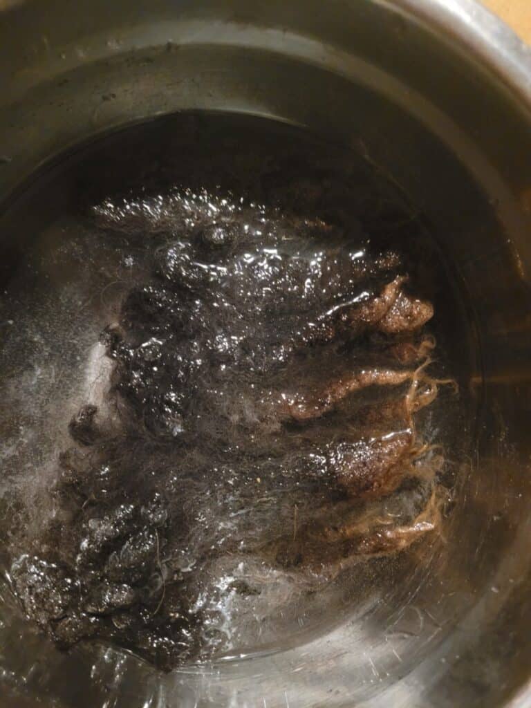 black wool being soaked in water