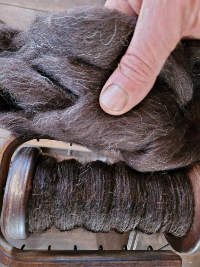 black yarn on bobbin and roving