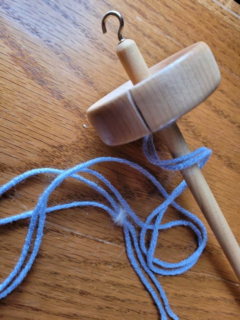 drop spindle with leader yarn attached