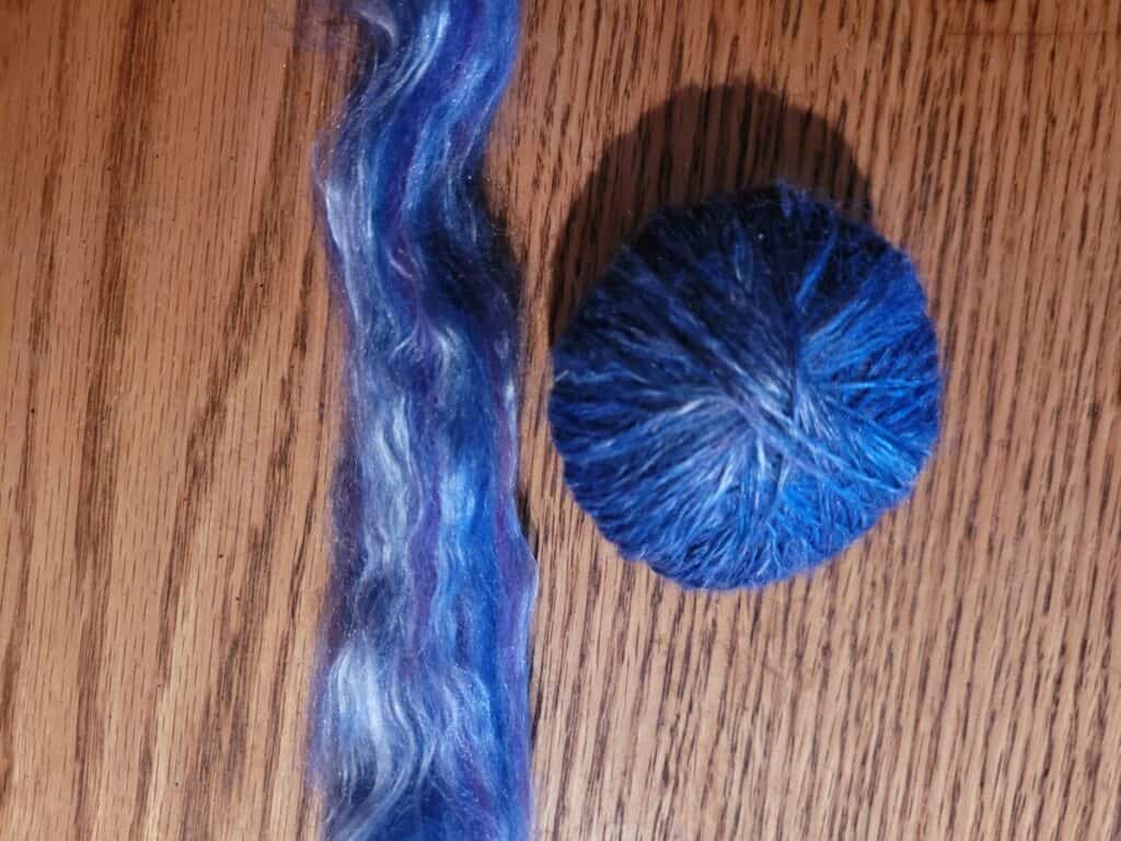 Merino and silk blend combed top beside yarn of same fiber that was spun worsted